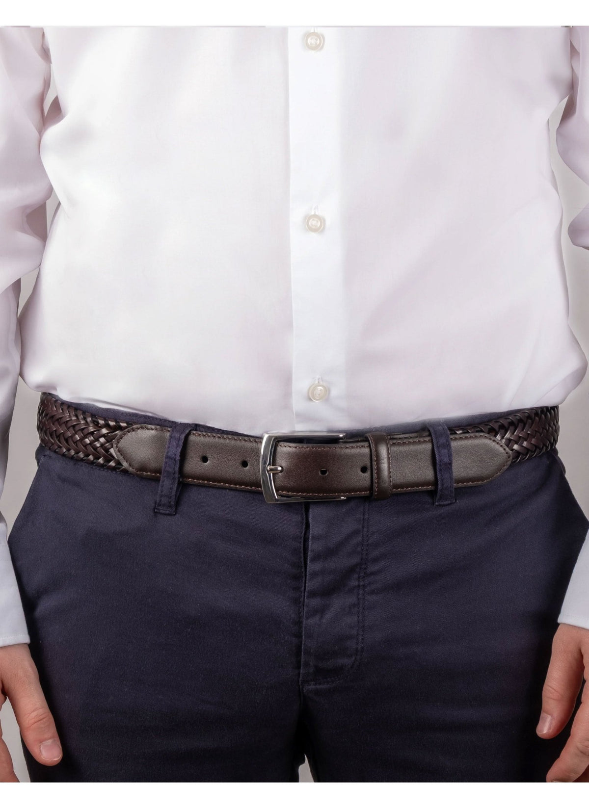 Dents men's brown plaited leather belt worn with white shirt and navy trousers
