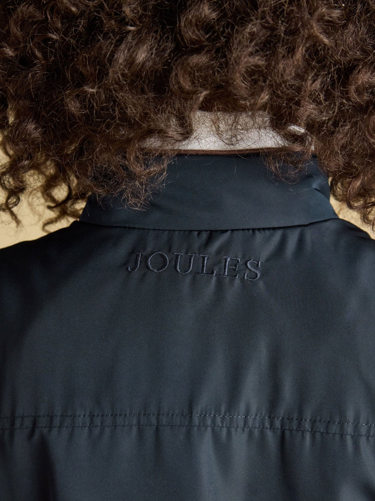 Joules ladies navy gilet back neck with embroidered Joules logo, close-up view
