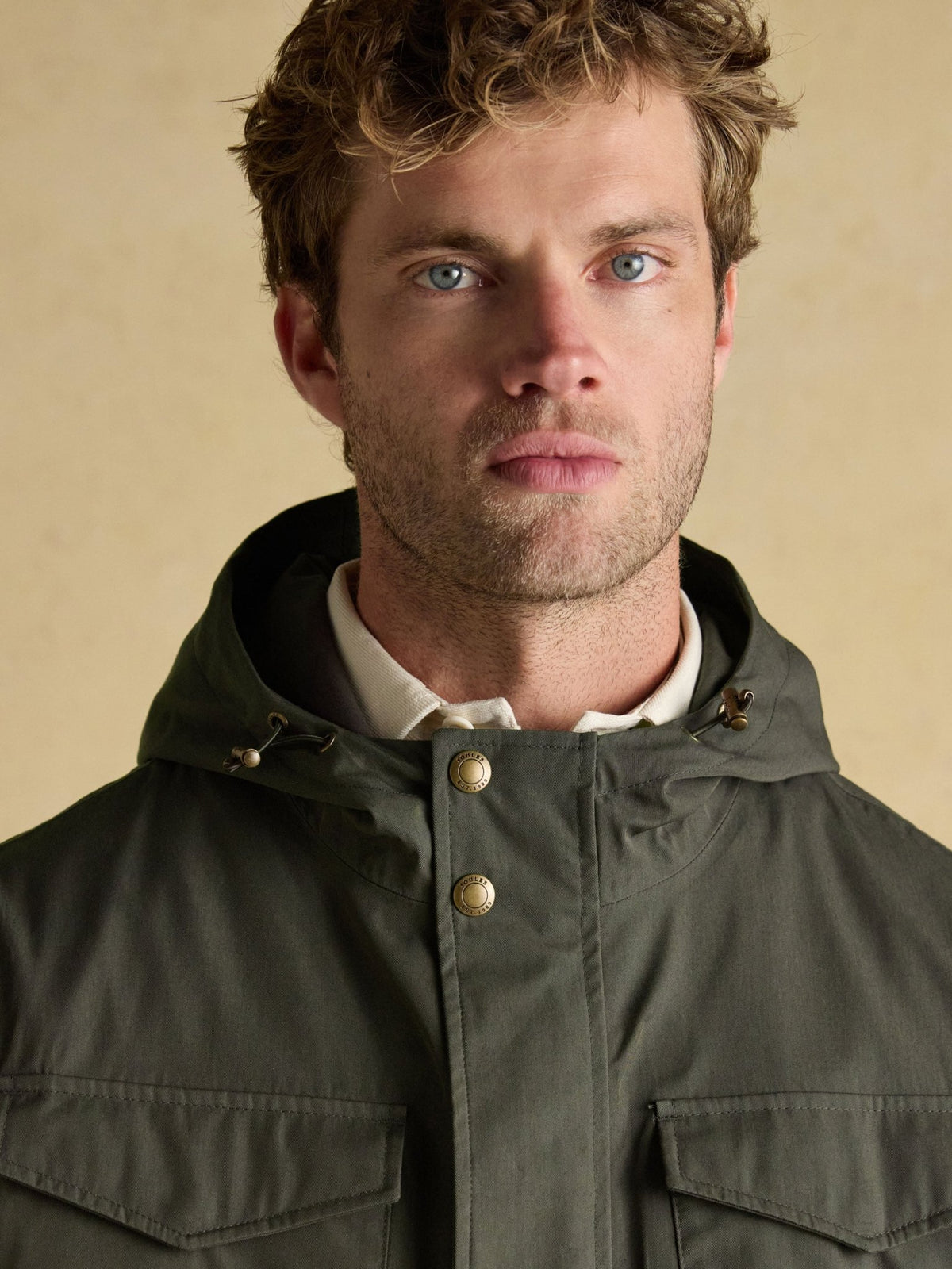 Joules men's green waterproof raincoat hood and button placket, close-up view
