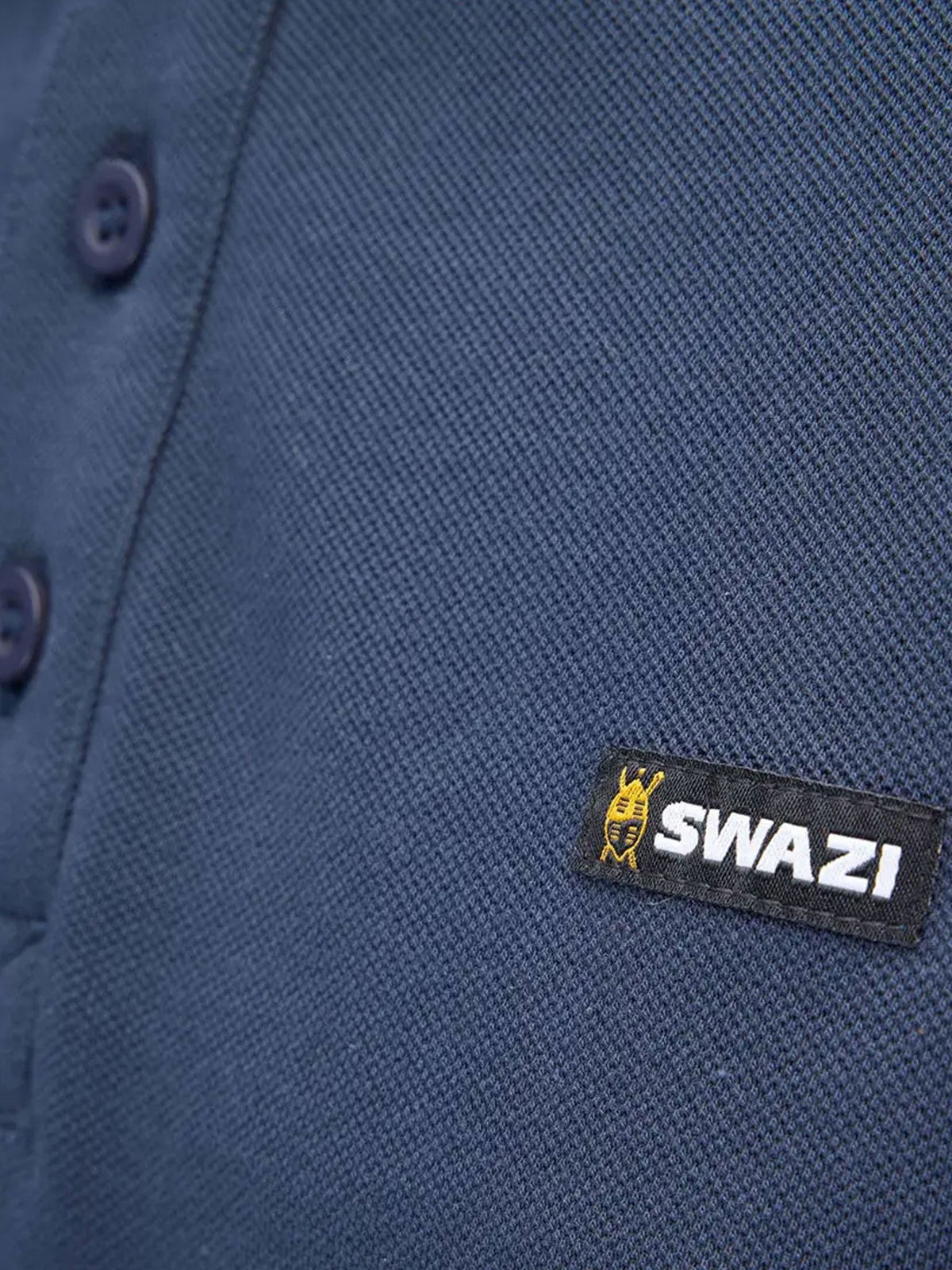 Close-up of Swazi logo tab on navy cotton piqué polo shirt