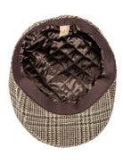 Inside of the Dents glen plaid tweed flat cap showing the quilted satin lining