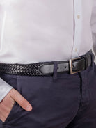 Dents men's black plaited braided leather belt worn with white shirt and navy trousers