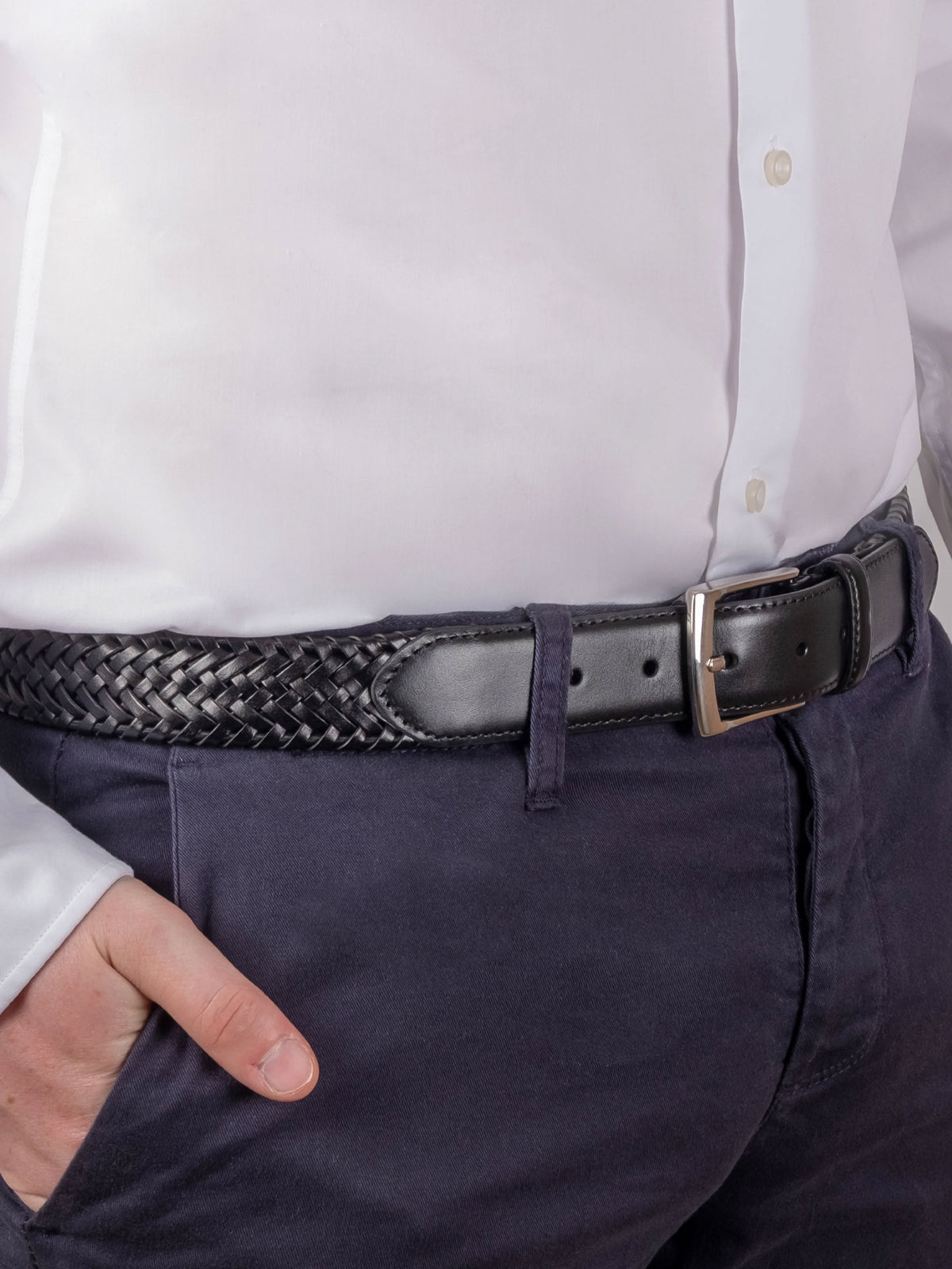 Dents men's black plaited braided leather belt worn with white shirt and navy trousers