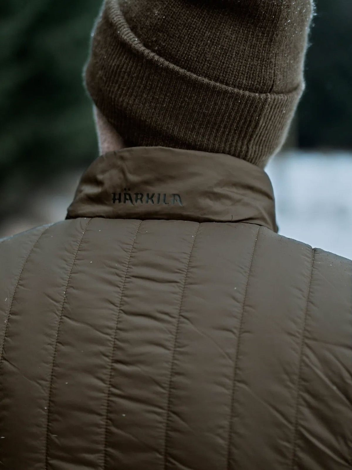 Harkila Heat men's insulated waistcoat worn by a model, rear close-up view
