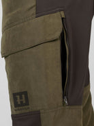 Härkila Scandinavian Trousers detail – thigh pocket with flap, ventilation zip and Härkila logo badge