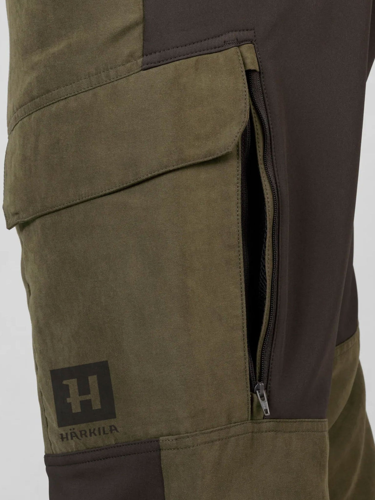 Härkila Scandinavian Trousers detail – thigh pocket with flap, ventilation zip and Härkila logo badge
