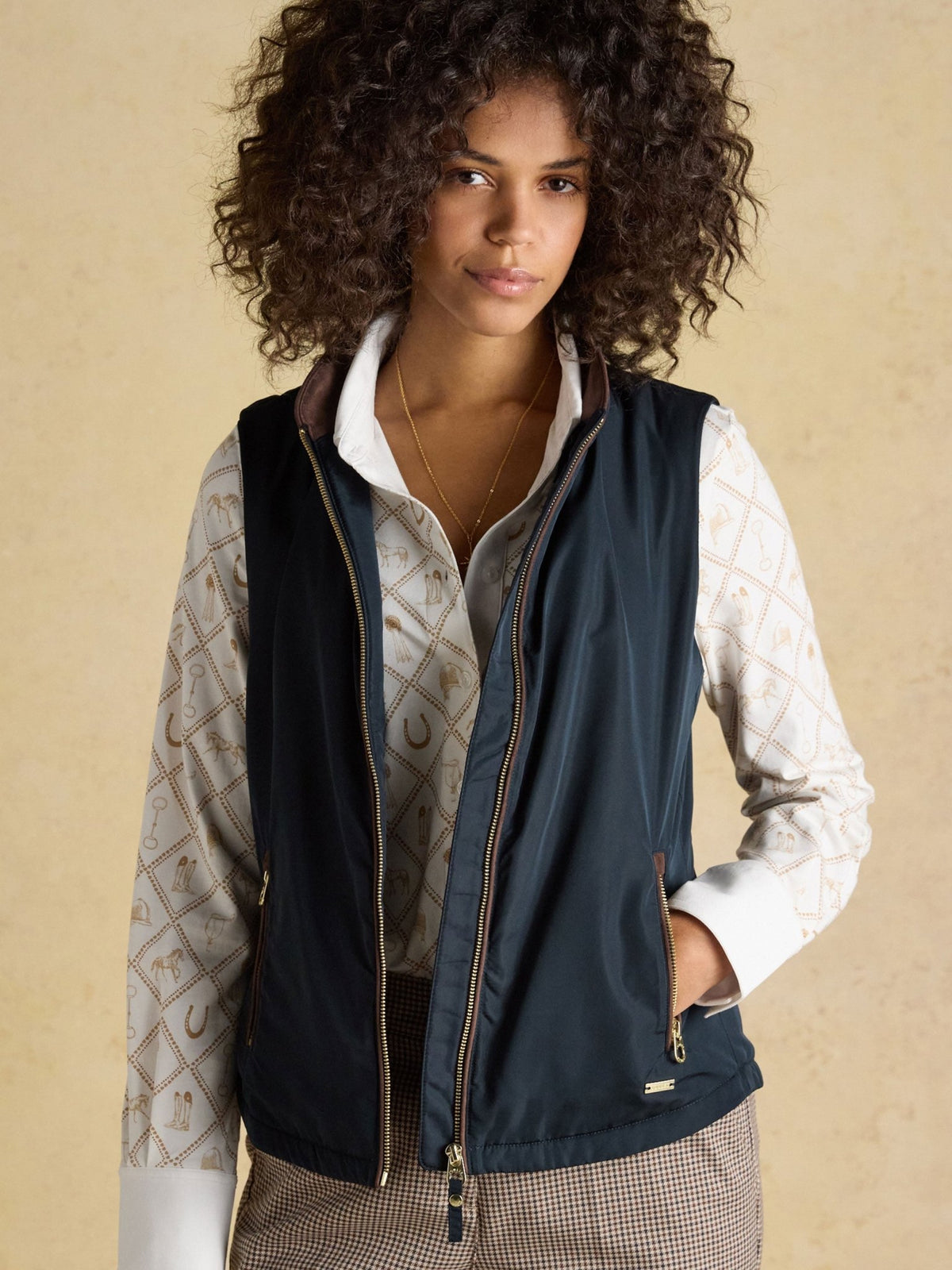 Joules women's navy bodywarmer gilet worn open over a cream shirt, lifestyle view