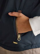 Joules ladies navy gilet zip pocket with brass zip and Joules tab, close-up view