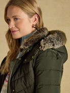 Joules Aspen long ladies showerproof padded coat in green with faux fur hood, view 5