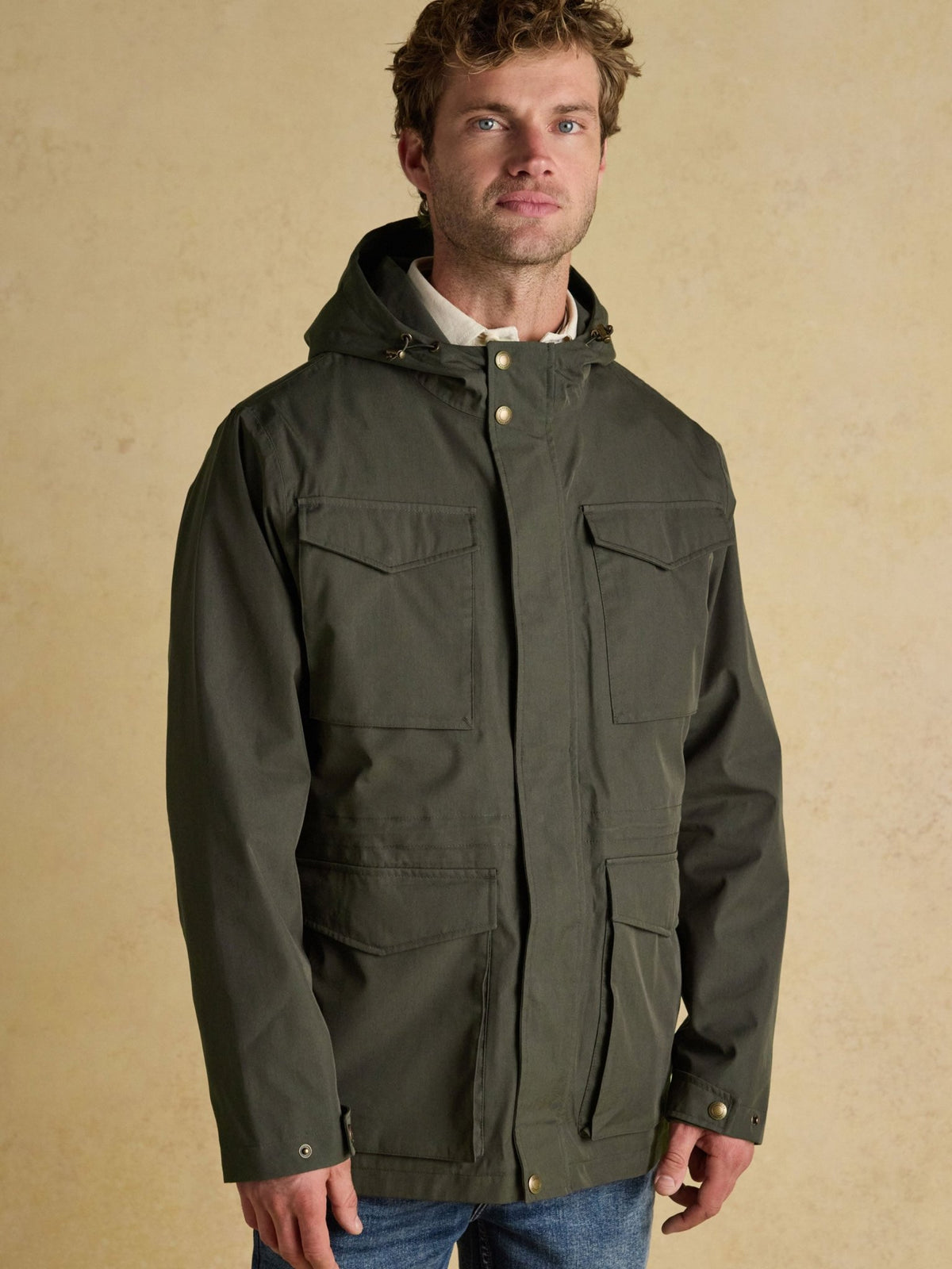 Joules men's green waterproof hooded raincoat with four front pockets, front view