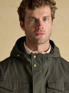 Joules men's green waterproof raincoat hood and button placket, close-up view