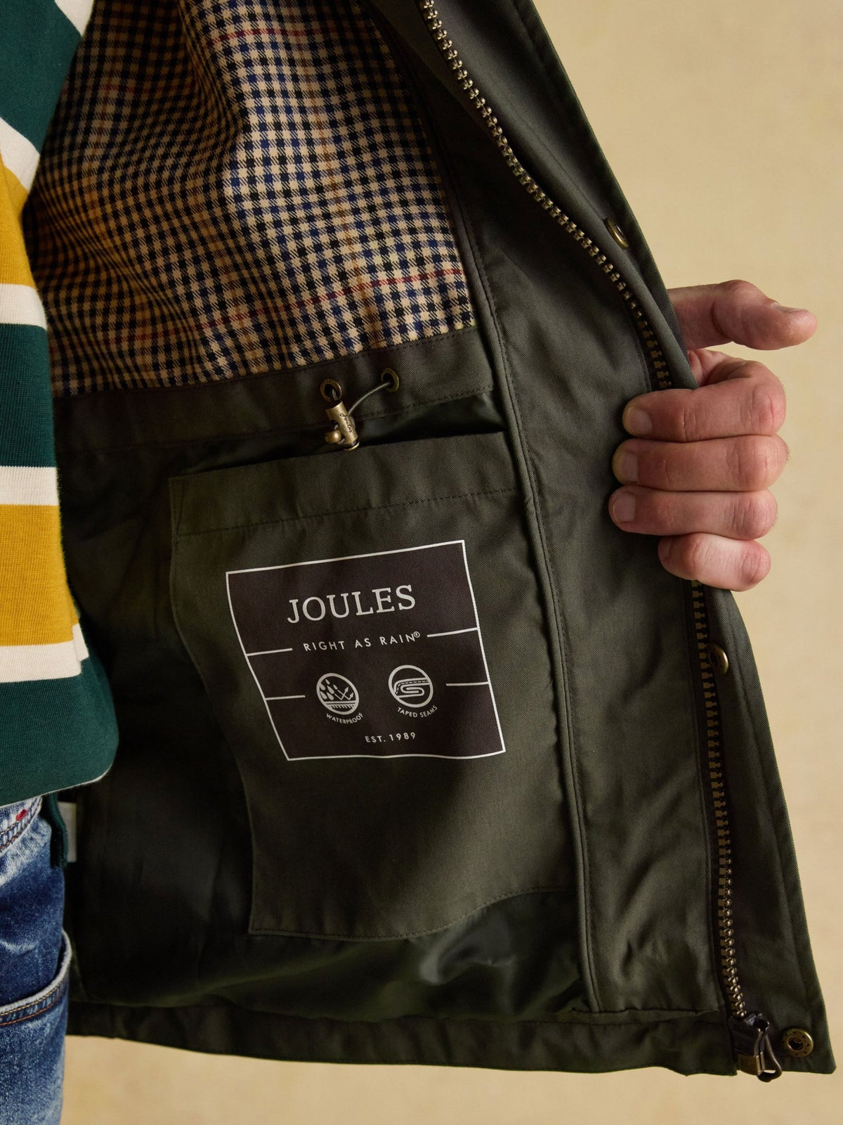 Joules men's green raincoat check lining and inside pocket with Joules label, interior view